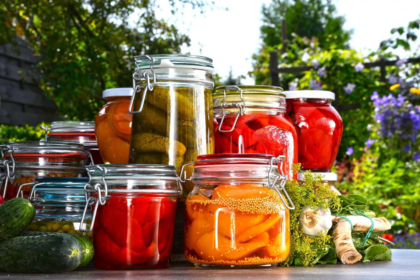 Jars of pickled vegetables and fruits in the garden