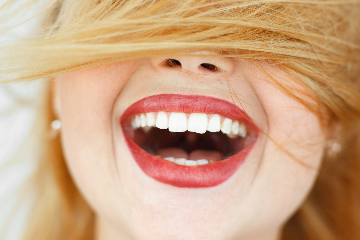 Happy laughing woman with red hair close-up. portrait of unrecognizable carroty girl with wide perfect smile. Fun, gladness, joy concept