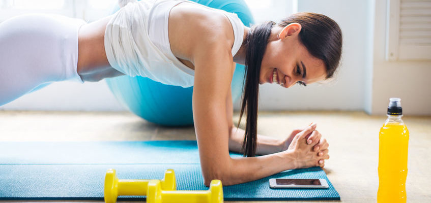 Ahtletic beautiful woman training at home - Young girl doing fitness in her apartment, concepts about fitness, sport and health